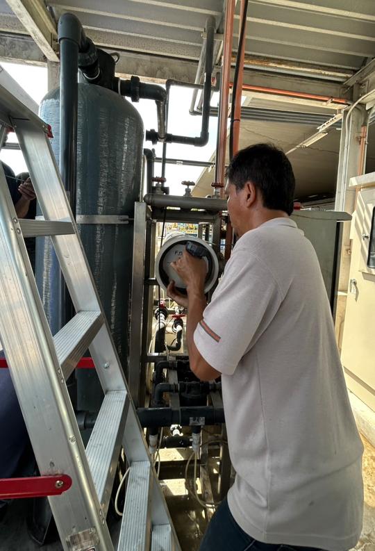 Technician servicing a filtration unit